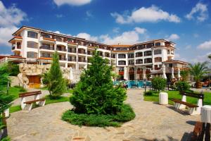 a large building with a christmas tree in front of it at The Vineyards Boutique Hotel & SPA in Aheloy