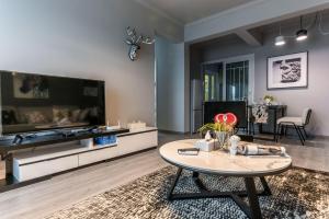 a living room with a large tv and a table at Chengdu Jinniu District North City No. 8 Locals Apartment 00169850 in Chengdu