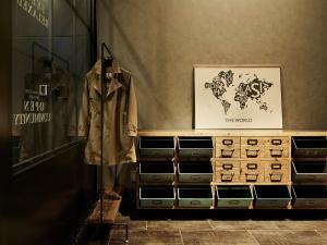 a store window with a dresser with a coat on it at the square hotel GINZA in Tokyo
