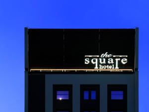 a sign for the square hotel on top of a building at the square hotel GINZA in Tokyo
