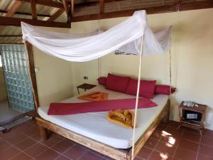 
a bed that has a canopy over it at Sleeping Trees in Koh Rong Sanloem
