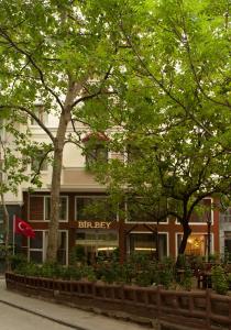 a building with a red flag in front of it at Birbey Hotel in Istanbul