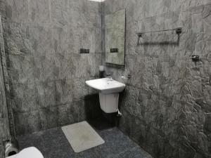 a bathroom with a sink and a mirror at Induwara Safari Resort in Udawalawe