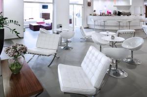 a living room with white chairs and tables at Yes Hotel Touring & SPA in Rimini
