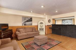 a living room with a couch and a tv at Super 8 by Wyndham Waco University Area in Waco