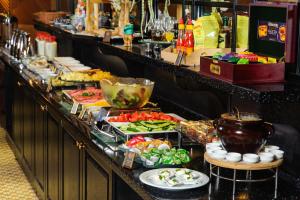 a buffet line with many different types of food at City Palace Hotel Tashkent in Tashkent