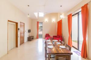 un comedor con una mesa larga en una habitación en StayVista at Greenwoods Villa 8 with Private Pool, Terrace, Lift & Ping-Pong Table, en Lonavala