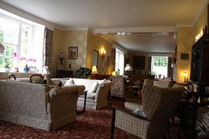 a living room with couches and chairs in a room at Lastingham Grange in Lastingham