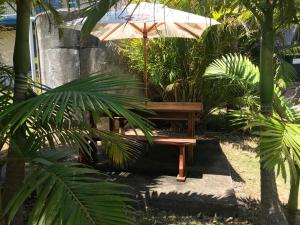 CurrarongにあるBull Ray Beach Houseの庭園内の木製ベンチ