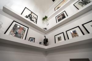 a gallery wall of framed pictures on a white wall at Bellini Suite in Naples