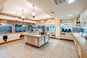 a large kitchen with blue and white counters at Stargorod Apart-Hotel in Kaluga