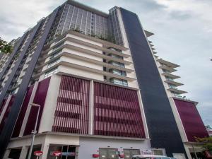 a large tall building with red and white at Maxhome @ D'Majestic Place, KL City Centre in Kuala Lumpur +1 photo