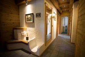 a hallway of a house with a mirror on the wall at Landhaus Erlzette in Tux