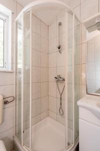a shower with a glass enclosure in a bathroom at Villa Gloria in Potomje +37 photos