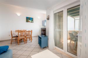 a living room with a view of a table and chairs at Villa Gloria in Potomje