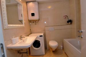 a bathroom with a sink and a washing machine at Apartments Annette - studio and two bedroom apartment with parking in Dubrovnik +34 photos