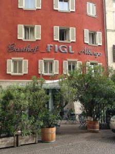 a building with a sign on the side of it at Hotel Figl ***S in Bolzano