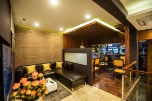 a living room with a couch and a table at Hotel Paramos Inn in Bangalore