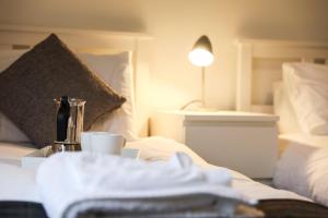 a hotel room with a bed with a coffee maker and a cup at Baron View Apartment in Paisley