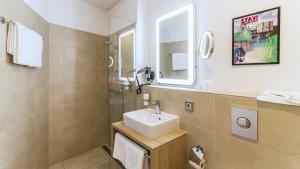 a bathroom with a sink and a mirror at Stay! Hotel Boardinghouse in Hamburg