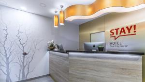 an office lobby with a stay hotel sign on the wall at Stay! Hotel Boardinghouse in Hamburg