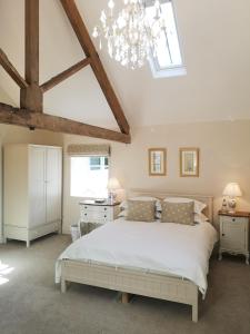 a bedroom with a large white bed and a skylight at Cleatham Hall in Manton