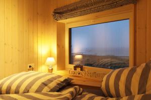 a room with two beds and a large window at Ferienhaus Jerup in Steinbergkirche