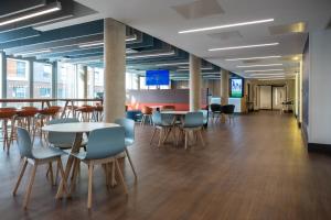 a large room with tables and chairs in a building at Elite Athlete Centre and Hotel in Loughborough