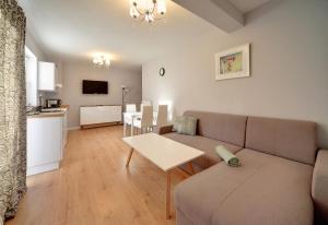 a living room with a couch and a table at Apartamenty EverySky - Wilcza 3F-2 in Karpacz