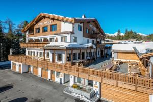 a large building with a snow covered roof at Hotel Sarain - Val Saraina Resort Lenzerheide in Lenz