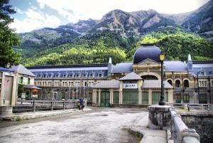 a large building with a mountain in the background at La Cabaña in Canfranc