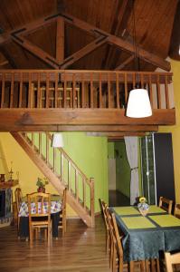 a dining room with a table and a staircase at La Cabaña in Canfranc