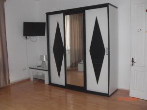a sliding glass door with a mirror in a room at Villa House Georgia in Tbilisi City