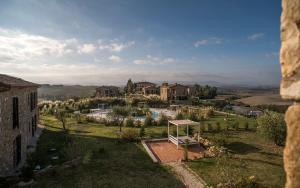 an aerial view of a house in a field at Tuscany Forever Premium Apartments in Volterra