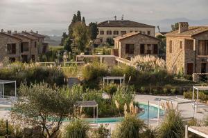 a view of a villa with a pool and buildings at Tuscany Forever Premium Apartments in Volterra