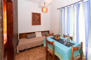 a dining room with a table and a bed at Apartments Mladenka in Poreč