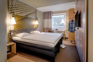 Postel nebo postele na pokoji v ubytování Ibis Münster City