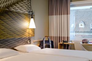 Postel nebo postele na pokoji v ubytování Ibis Münster City
