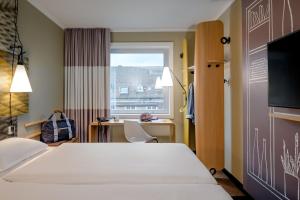Postel nebo postele na pokoji v ubytování Ibis Münster City