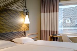 Postel nebo postele na pokoji v ubytování Ibis Münster City