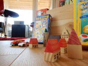 a toy house on a table with toy cars at Bungalow Nr_2 bei Wismar _ Ostsee in Zierow