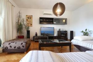 a living room with a couch and a tv at House Lipo in Makarska