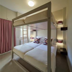 a bedroom with two bunk beds and a window at Amitges by FeelFree Rentals in Baqueira-Beret