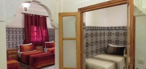 a room with a mirror and a bed and a chair at Dar HAJAR in Marrakech +55 photos