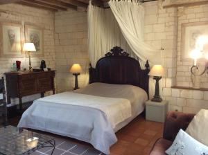 a bedroom with a bed and a table and two lamps at Manoir Francis in Marles-sur-Canche