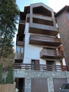 a building with balconies on the side of it at STILL Apartament Sinaia in Sinaia +20 photos