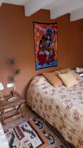a bedroom with a bed and a painting on the wall at Casa Montseny con piscina,bosque in Sant Pere de Vilamajor
