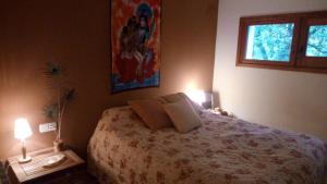 a bedroom with a bed with two lamps and a window at Casa Montseny con piscina,bosque in Sant Pere de Vilamajor