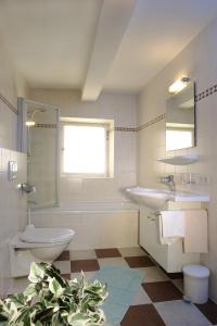a bathroom with a sink and a toilet and a mirror at Ferienhaus/Chalet Schneiderhäusl in Flachau