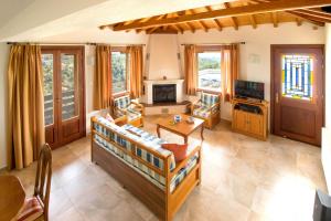 a living room with a couch and a table at Armamento Villa in Skiathos
